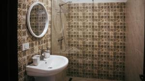 a bathroom with a sink and a mirror at AristoCat Hotels Rasnov in Râşnov +82 photos