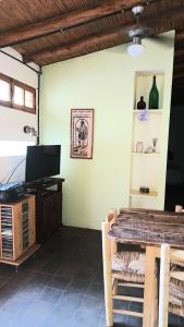 a dining room with a table and a television at El Parralito in Mendoza