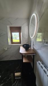 a bathroom with a sink and a mirror at CASA RURAL LALLANTA in Pedroso