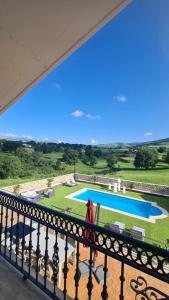 a balcony with a view of a swimming pool at CASA RURAL LALLANTA in Pedroso