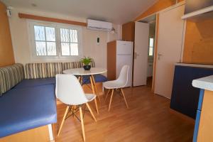 a small kitchen with a table and chairs in a room at ZALUAY - Mobile Homes in Isla Cristina
