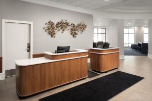 an office with two reception desks and a chandelier at Courtyard by Marriott Chicago at Medical District-UIC in Chicago