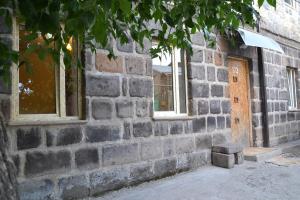 a brick wall with two windows on a building at My Home in Gyumri