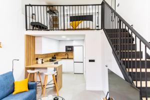 a kitchen and a living room with a staircase at Loft 11 A in Murcia