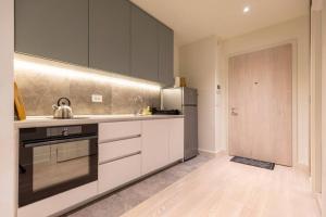 a kitchen with a sink and a refrigerator at Galerija Libera in Belgrade