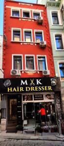 a red building with a hair dresser sign on it at Family Hotel Taksim in Istanbul