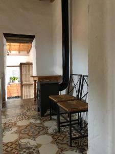 a room with a bench and a table and a piano at Finca el Fuenton in Málaga
