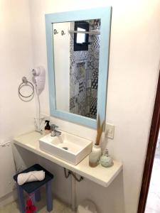a bathroom with a sink and a mirror at Cielos de Maimará in Maimará