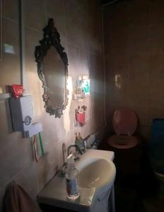 a bathroom with a sink and a mirror and a toilet at Felix Felicis 