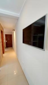 a hallway with a large flat screen tv on a wall at Gala Apart Boutique & Spa -sólo para adultos- in Mar de las Pampas