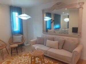 a living room with a couch and a mirror at El Mirador Del Alcazar in Segovia