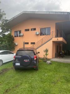 a car parked in front of a house at Sky Hostel in Fortuna