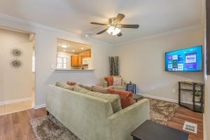 a living room with a couch and a flat screen tv at Cabin Style & Cozy Back Deck Near LakePoint PBR in Cartersville