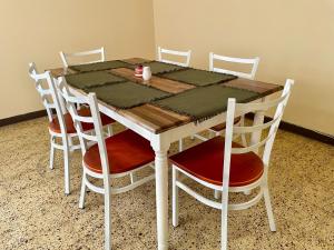 a wooden table with four chairs at Casa Quetzal in Guatemala