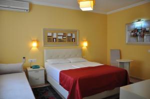 Postel nebo postele na pokoji v ubytování Hotel Pik Loti