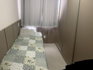 a small room with two beds and a window at Apartamento Ponta Verde. Edf. Promenade II in Maceió
