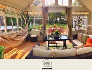 a living room with a couch and a hammock at Daweswood Guest Suite - Luxury retreat with optional hot tub in Canterbury