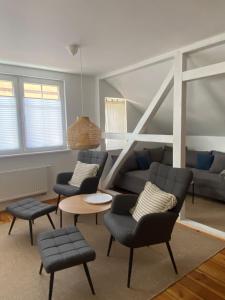 a living room with a couch and chairs and a table at Ferienwohnung im Dreiseitenhof in Großräschen +5 photos