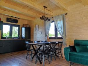 a kitchen and dining room with a table and chairs at Przystanek Śnieżka in Kowary