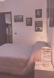 a bedroom with a bed and a table with books at Casa vacanze Marinella in SantʼEufemia Lamezia +12 photos