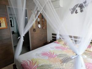 a bedroom with a bed with a canopy at Chamb'Bouchons in Saint-François