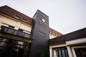 a black building with a sign on the side of it at Hotel Relax Craiova in Craiova