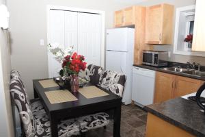 una cocina con una mesa con un jarrón de flores. en Sam & Comfort Home en San Juan de Terranova