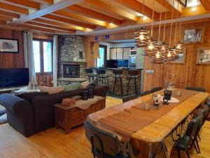 a living room with a large wooden table and a couch at Chalet Aussois, 6 pièces, 14 personnes - FR-1-508-28 in Aussois