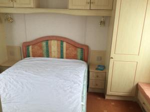 a small bedroom with a bed and two night stands at H2 in Aberystwyth