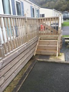 a wooden fence in front of a house at H2 in Aberystwyth