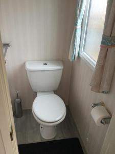 a small bathroom with a toilet and a window at H2 in Aberystwyth