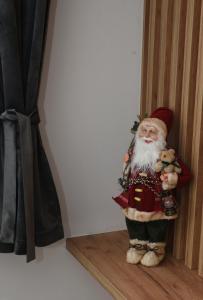 a santa claus figurine sitting on a shelf at Zlatni Javor Twins in Jahorina
