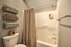 a bathroom with a toilet and a shower with a shower curtain at Anglers Pointe in Branson