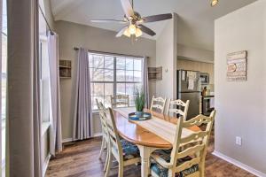 a dining room with a table and chairs and a ceiling fan at Anglers Pointe in Branson