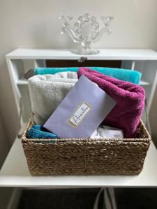 a basket filled with towels on a shelf at VIP Suites for Business Women, Nurses, College Moms Traveling to Indianapolis in Indianapolis +63 photos