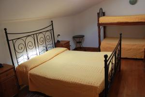 a bedroom with two beds and a dresser at B&B Al Borgo in Ravenna