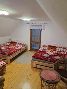 a bedroom with two beds and a window at Chata U lesa in Svoboda nad Úpou