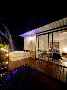 a room with a bed on a deck at night at Cabañas Bellavista La Vega in La Vega