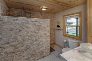 a bathroom with a toilet and a sink at Cozy Home, Hot Tub, Dock, Kayaks, Swimming & More! in Woodrow +33 photos