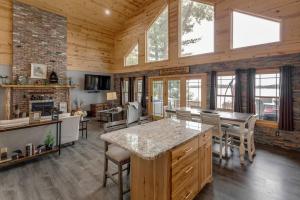 a kitchen and dining room in a log cabin at Cozy Home, Hot Tub, Dock, Kayaks, Swimming & More! in Woodrow