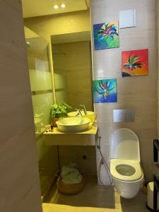 a bathroom with a sink and a toilet and a mirror at Cosy appartement à Ain Diab beach in Casablanca