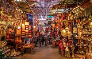 aazaar with people walking through a market with many shops at Fassia in Fez