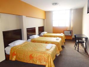 En eller flere senge i et værelse på Hotel Gran Sipan