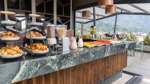 a buffet line with various food items on display at Hotel F25 in Ibagué