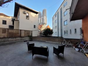 a patio with chairs and a table and buildings at HelloZagreb Apartment in Zagreb
