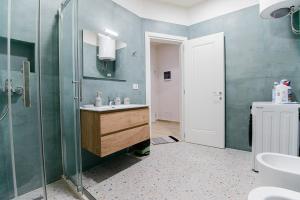 a bathroom with a sink and a glass shower at Loris Apartaments 203 in Durrës +18 photos