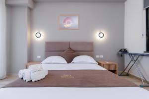 a bedroom with a large bed with towels on it at Loris Apartaments 203 in Durrës