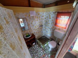 a small bathroom with a toilet and a sink at GENTE D'AQUI Ngê D'ai êê in São Tomé