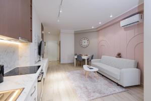a living room with a white couch and a table at Loris Apartaments 203 in Durrës