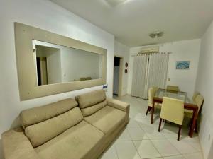 a living room with a couch and a table at APARTAMENTO PRAIA BOMBINHAS in Bombinhas